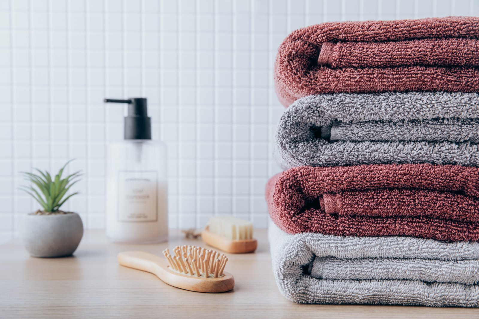 Towels. Clean fresh fluffy towels and bath accessories on table in bathroom