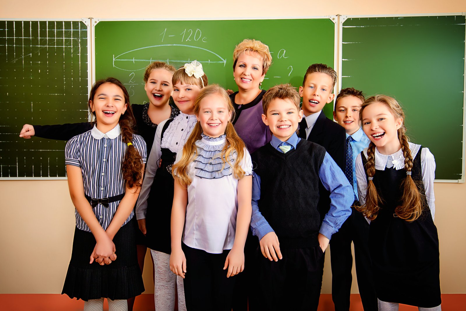 Happy schoolchildren at a classroom. Education.