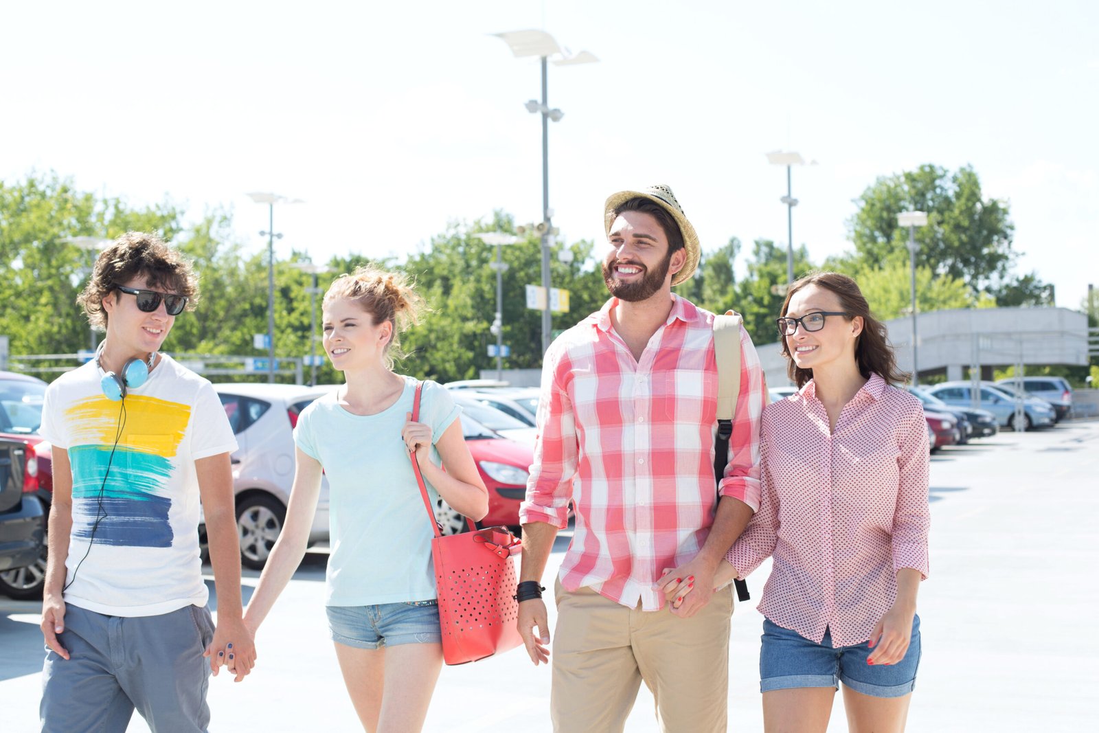 Happy male and female friends walking on city street