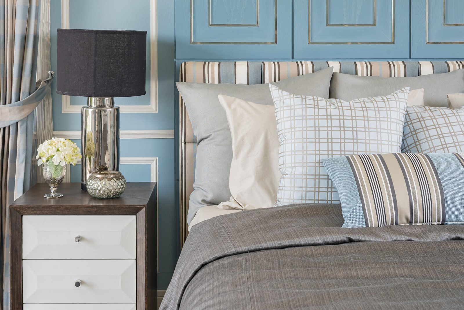 classic lamp style on wooden table in blue bedroom with classic bed and pillows