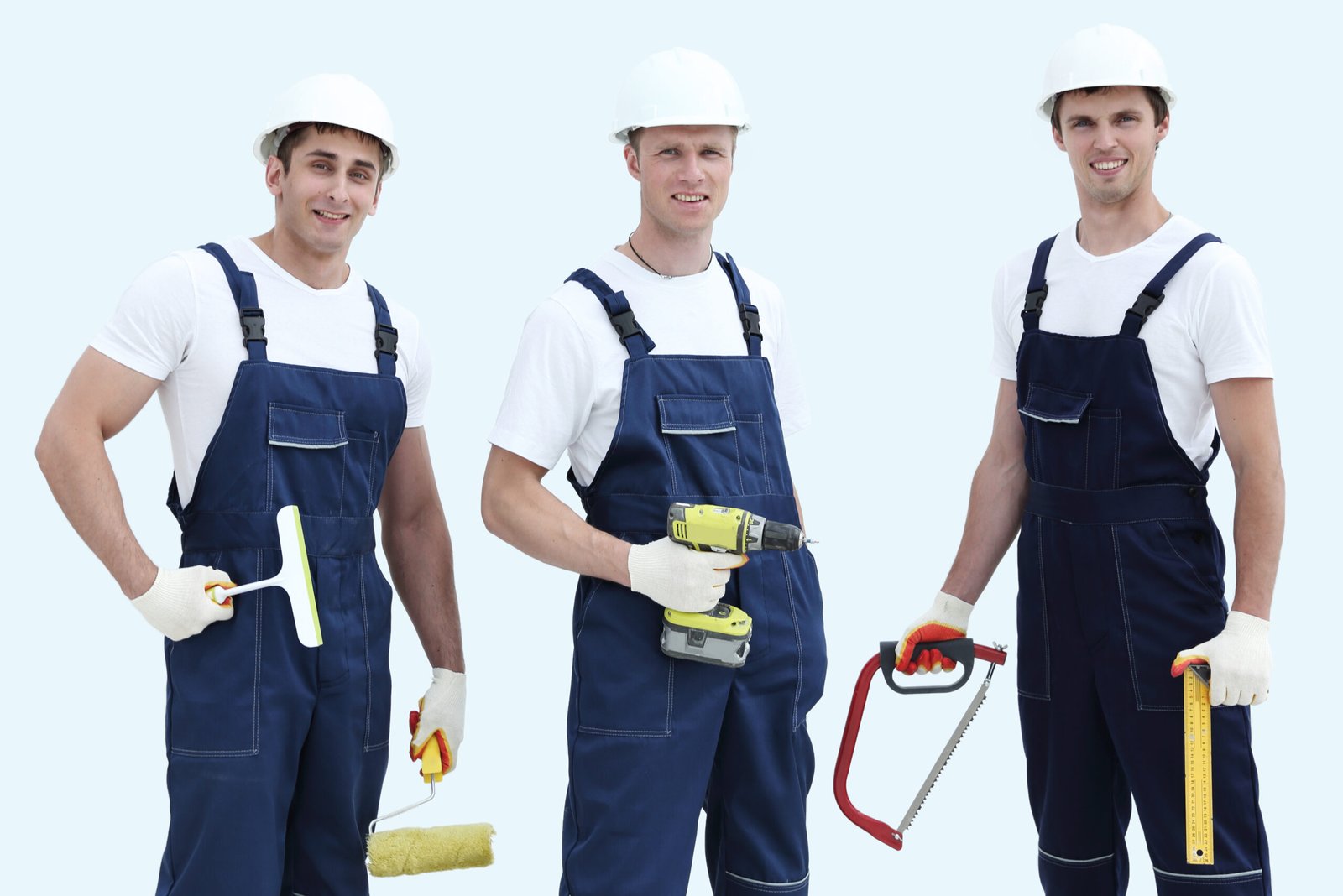 Group of builders in overalls isolated on white background